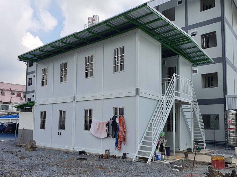 Large two-story container building with external stairs