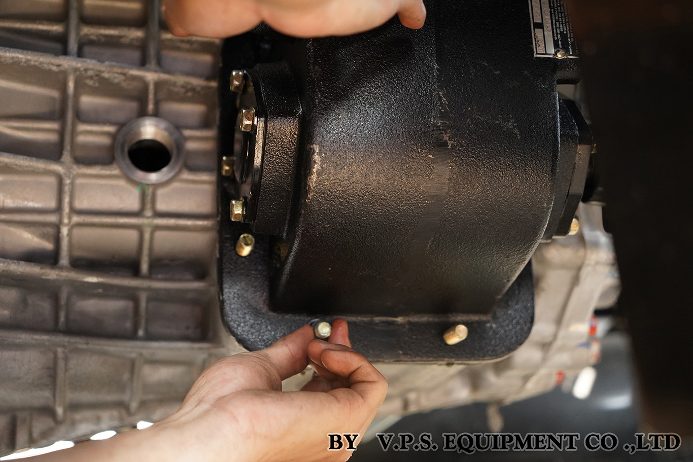 Technician fitting a VPS PTO to a truck gearbox