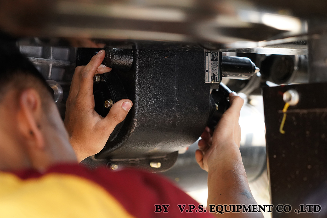 Technician fitting the shift control to a PTO during installation on a truck transmission