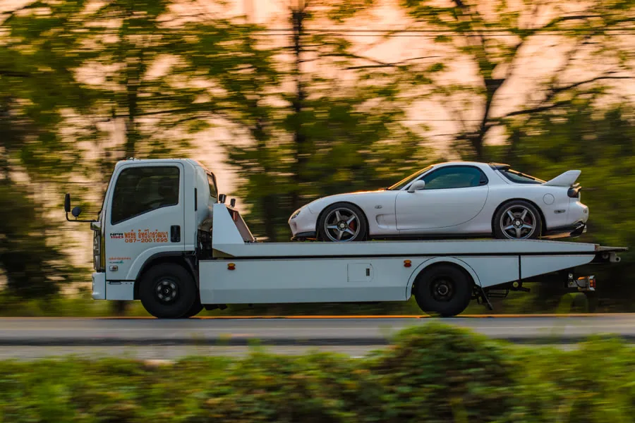 รถสไลด์ — slide-bed carrier truck, the deck driven by a PTO and hydraulic pump