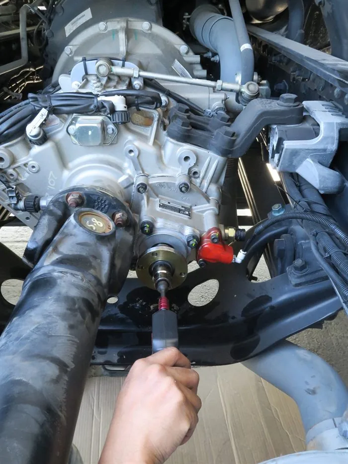 VPS technician torquing a PTO drive shaft bolt during installation